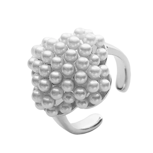 Macro detail of silver adjustable ring featuring clustered oval white pearls and star accents