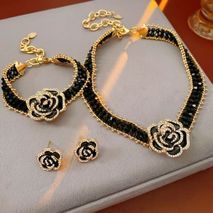 Close-up of luxury black rose jewelry set with necklace and earrings on velvet