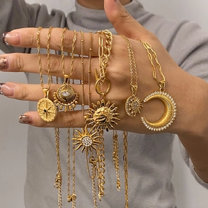 Gold stainless steel necklace with sun moon star and evil eye pendants set in hand
