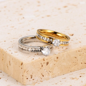 Six-prong gold and silver stainless steel couple rings with cubic zirconia settings