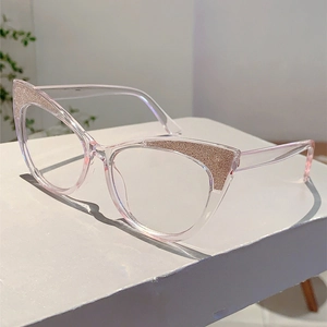Detailed view of pink cat-eye glasses frame with glitter accents on white background
