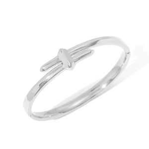 Minimalist silver stainless steel bangle with polished knot design on white background