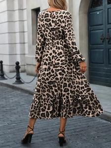 Detail of leopard print midi dress with elastic high waist and ruffled hemline