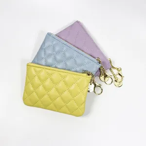 Set of three quilted faux leather coin purses in yellow, blue and purple with gold zippers