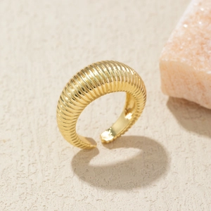 Macro shot of 18K gold plated croissant dome ring with textured vertical stripes