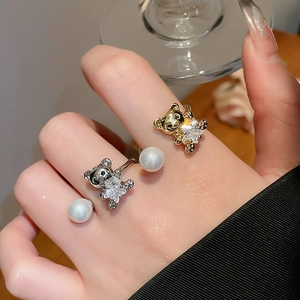Detail of bear ring featuring a star zircon and pearl on a gold adjustable band