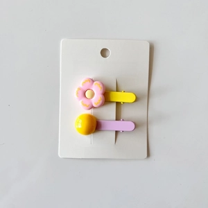 Set of 2 colorful flower and bead hair clips for girls on a white card display