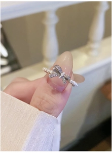 Close-up of silver bow ring with white pearls and sparkling cubic zirconia stones