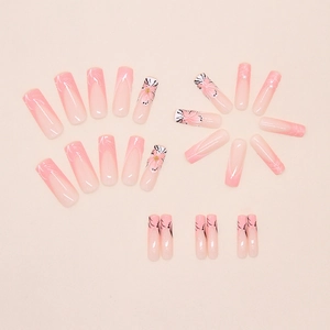 Macro shot of long ballerina press-on nails with 3D floral designs and pearls
