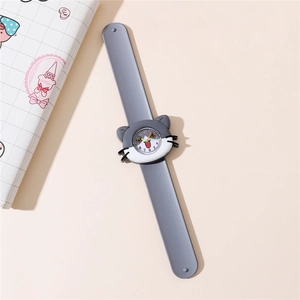 Close-up of kids cartoon cat quartz watch with grey silicone strap on beige background