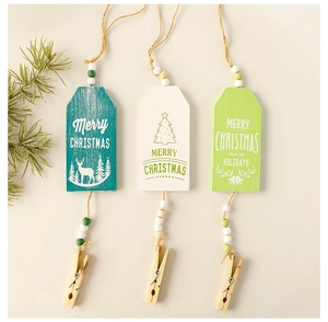 Detailed view of three festive wooden Christmas tree tags with clips and colorful beads