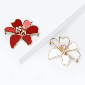 Elegant lily flower brooches in red enamel and white shell with crystal accents