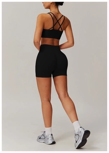 Side-back view of black yoga set with cross-back sports bra and lifting shorts