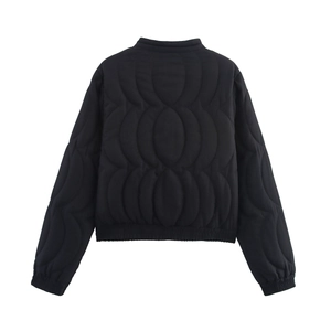 Detailed back view of black quilted jacket with circular embroidery and elastic cuffs