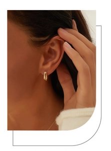 Close-up of elegant irregular S925 silver earring with 14K gold plating and micro-set zircons