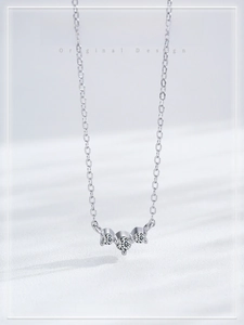 Detailed macro view of S925 sterling silver necklace with three radiant zircon stones