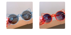 Detail shot of cute cat ear sunglasses in transparent blue and orange frames for children