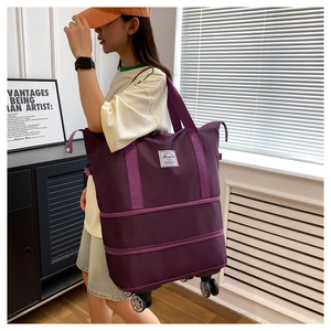 Purple expandable travel bag with swivel wheels and large capacity for women