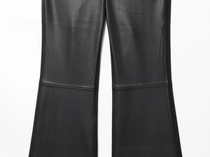 Close-up of black faux leather flared pants showing stitch detail and seam texture