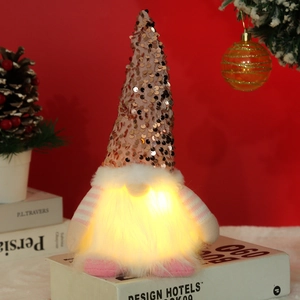 Detailansicht eines leuchtenden Weihnachtswichtels mit Paillettenhut und Kunstfellbart