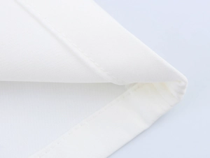 Close-up of white fabric texture and precision double-stitched seams on women's vest set