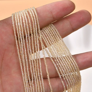 Macro detail of 2mm faceted amber crystal beads with iridescent finish for jewelry making