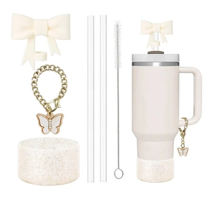 Beige tumbler accessory set with glitter boot, bow, butterfly chain and straw cover
