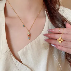 Golden necklace set with hollow clover pendant and turquoise vintage charm
