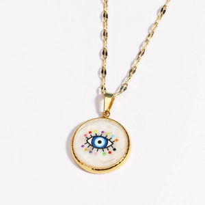Macro detail of golden Evil Eye pendant necklace with multi-colored dot accents