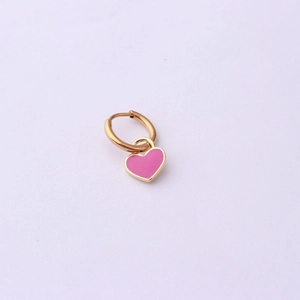 Detail view of pink heart pendant on golden steel hoop earring with enamel finish