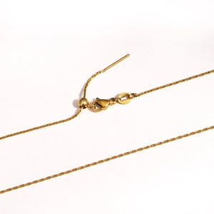 Detail of 18k gold plated titanium necklace featuring adjustable sliding bead and lobster clasp