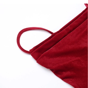 Close-up of red velvet dress fabric showing spaghetti straps and soft texture detail