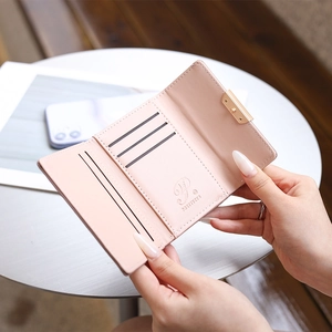 Pink striped tri-fold leather wallet for women with multiple card slots and buckle closure