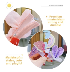 Close-up of fabric-covered hair clips with bow, heart, and rainbow patterns for girls