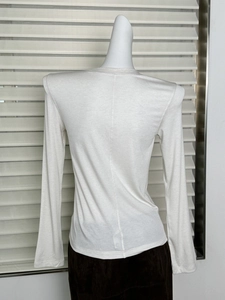 Detailed back view of white long sleeve wool t-shirt with slim fit vertical seam design