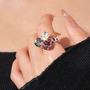 Detail of cubic zirconia square ring with cuban chain band on model finger