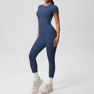 Close-up of seamless dark blue high-stretch yoga set featuring leggings and short sleeve top