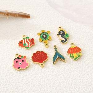 Detailed set of 7 gold stainless steel marine animal charms with colorful enamel finish