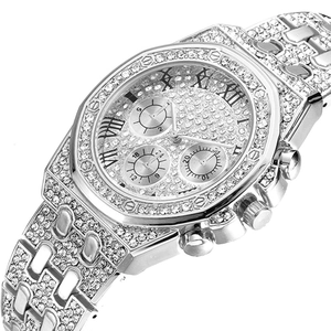 Detailed macro view of silver iced-out watch featuring octagonal bezel and roman numerals
