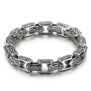 Vintage silver titanium steel bracelet with intricate floral engravings and a bold design
