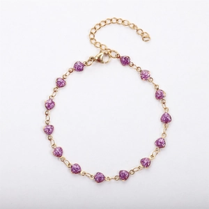 Detail of 18k gold plated chain bracelet with purple glitter heart charms and lobster clasp
