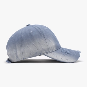 Vintage light blue washed cotton baseball cap with distressed rip details and adjustable strap