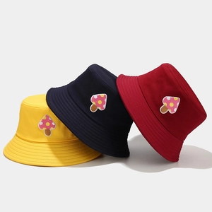 Three colorful cotton bucket hats in yellow navy and red with cute mushroom embroidery