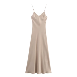 Detail of champagne satin midi dress showing the sleek silk texture and V-neckline