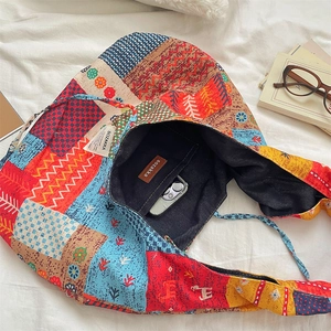 Detail of bohemian patchwork corduroy tote bag showing interior denim lining and spacious pocket