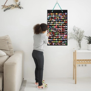 Wall-mounted black felt pin display organizer with colorful badges and teal hanging cord