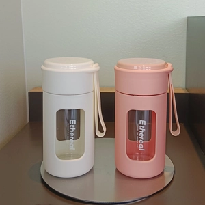 Detail of portable glass water bottles with silicone sleeves and carrying straps