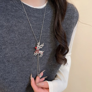 Detail of Christmas reindeer necklace with sparkling rhinestones and a snowflake charm