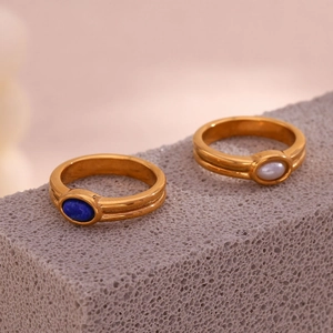 Detail of 18K gold plated rings with blue natural stone and white pearl on stone base