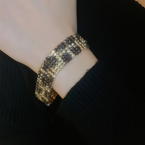 Close-up of leopard print bracelet with sparkling rhinestones in black and gold finish